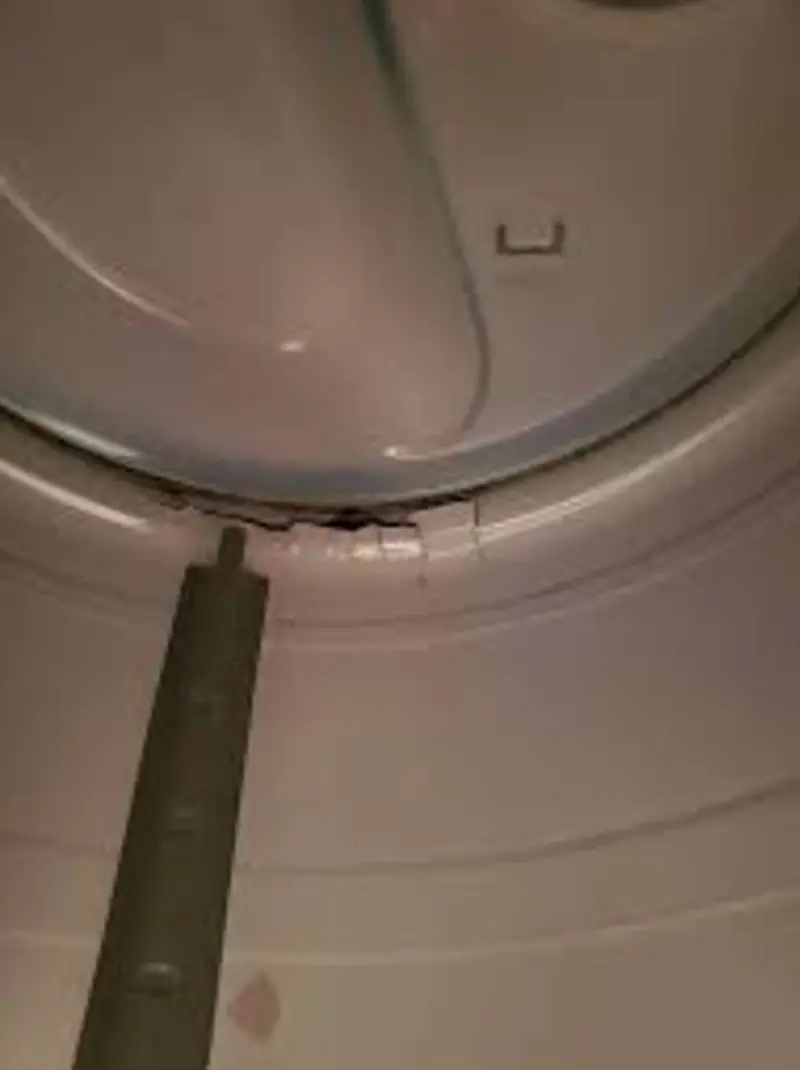 Scored LG dryer drum interior surface — sharp edges catching clothes